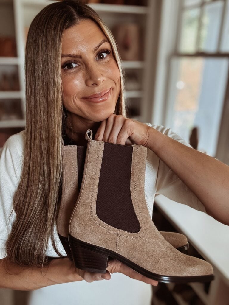 Corrine holding a pair of Clemens Chelsea Boots